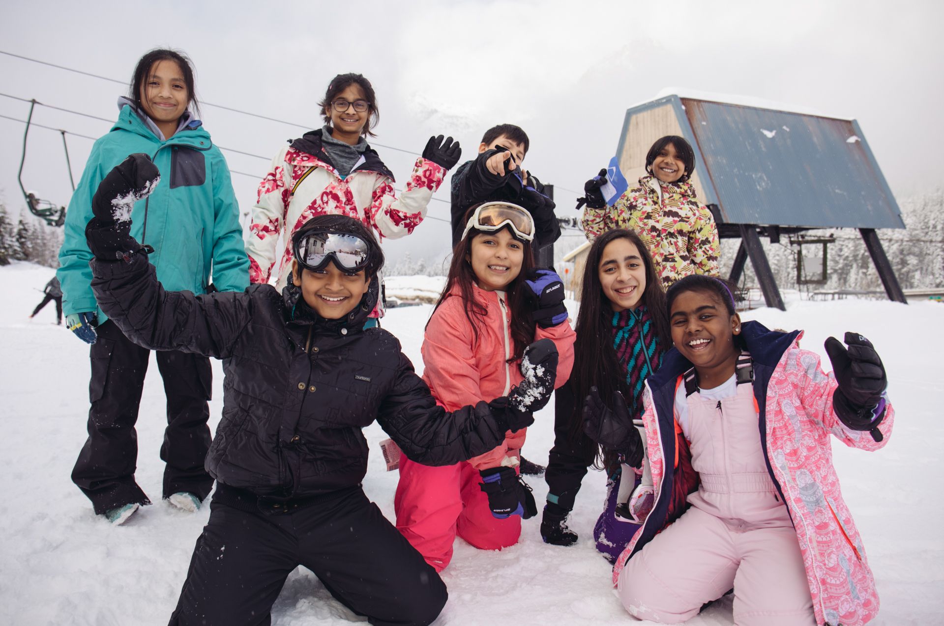 kids smile standing on a ski slope together